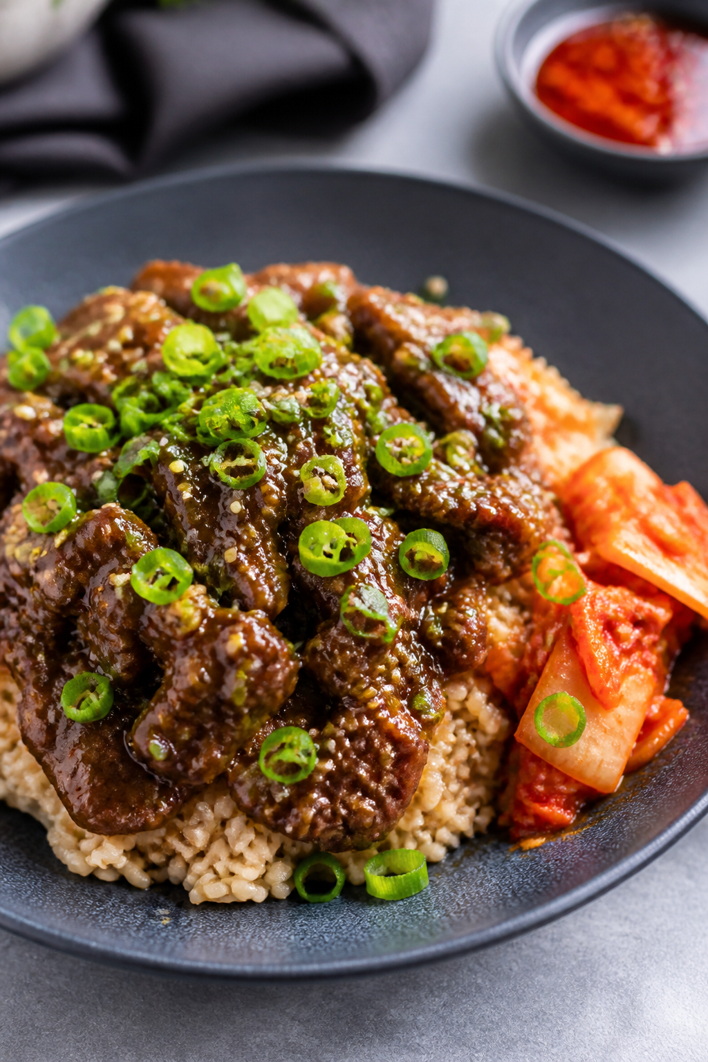 Final dish presentation: Restaurant-quality plated beef bowl variation with brown rice—beef mounde