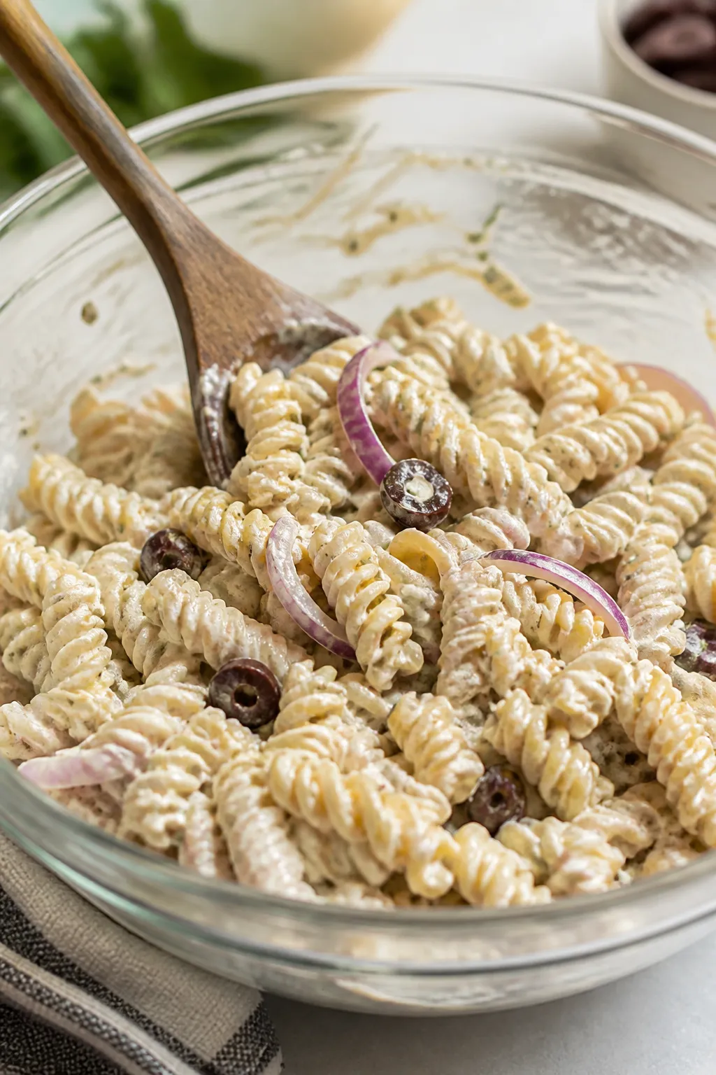 Cooking process: Al dente rotini just drained and briefly rinsed, steam faintly rising, tossed in a 