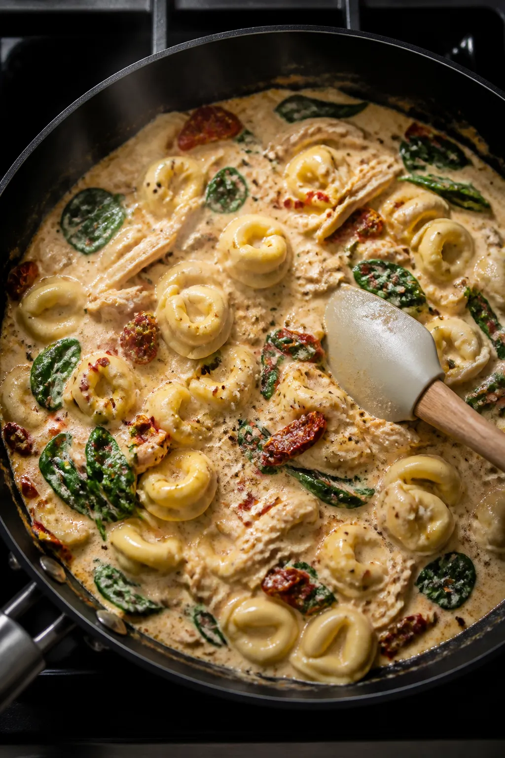 Cooking process: One-pan tortellini simmering in the creamy chicken-broth and half-and-half sauce as