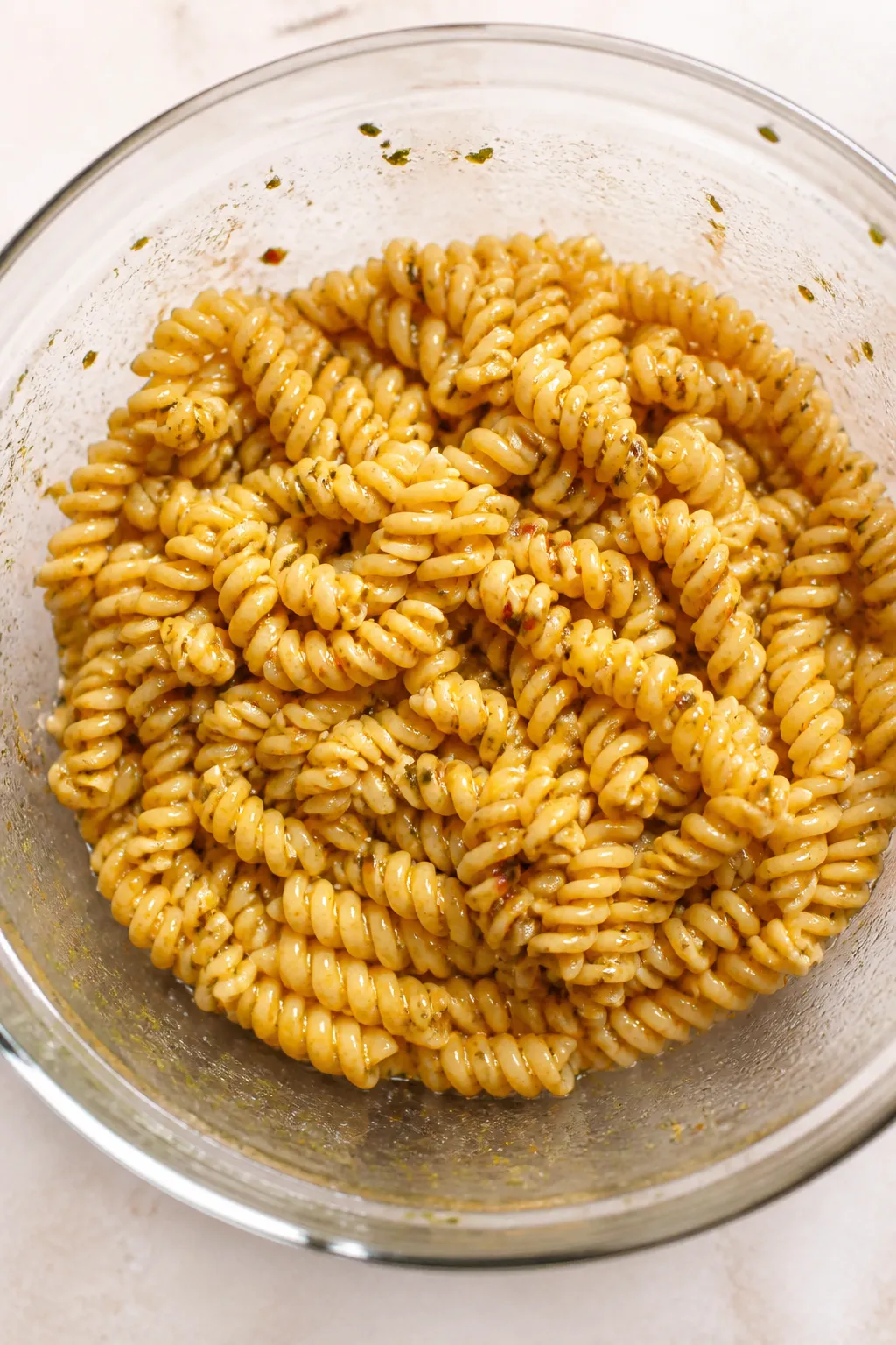 Cooking process, overhead shot: Al dente rotini just drained and rinsed, still steaming slightly, be