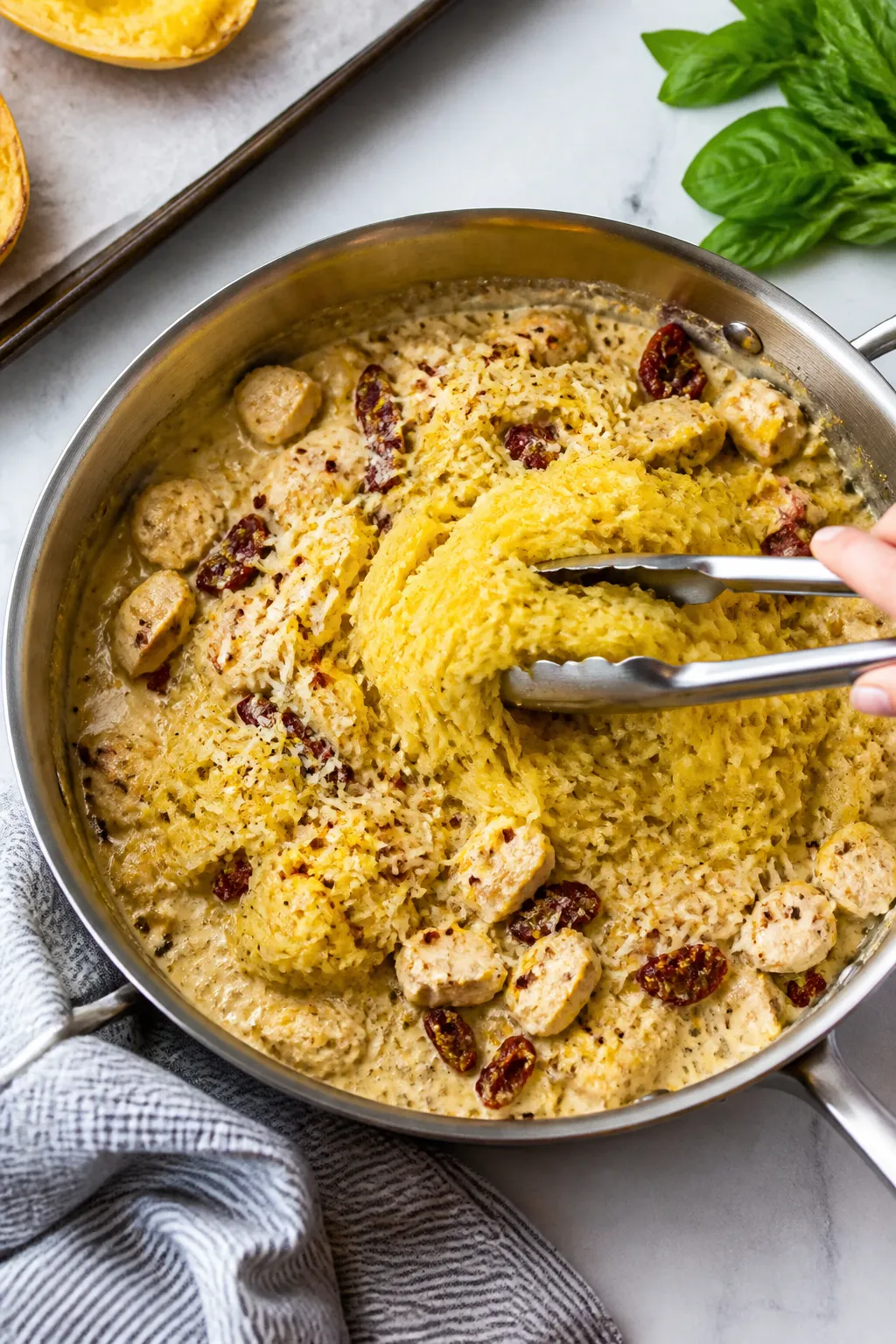 Cooking process: Overhead shot of roasted spaghetti squash strands just added to the skillet of silk
