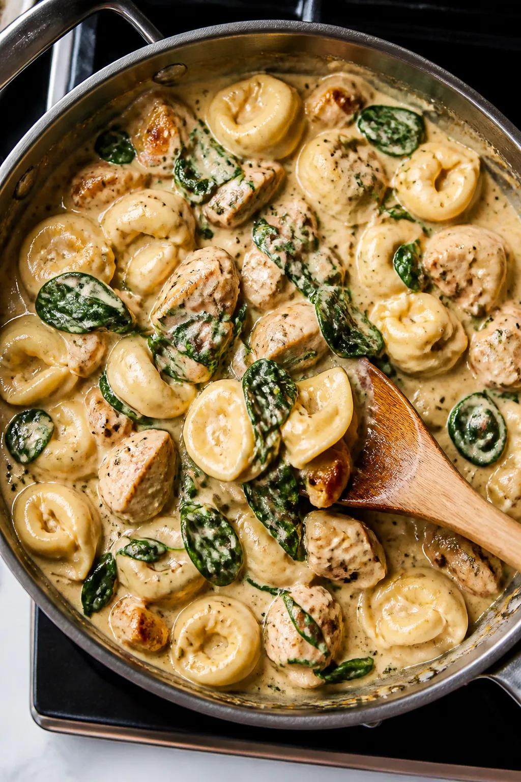 Cooking process: Overhead shot of the one-pan tortellini coming together—cheese tortellini and bro