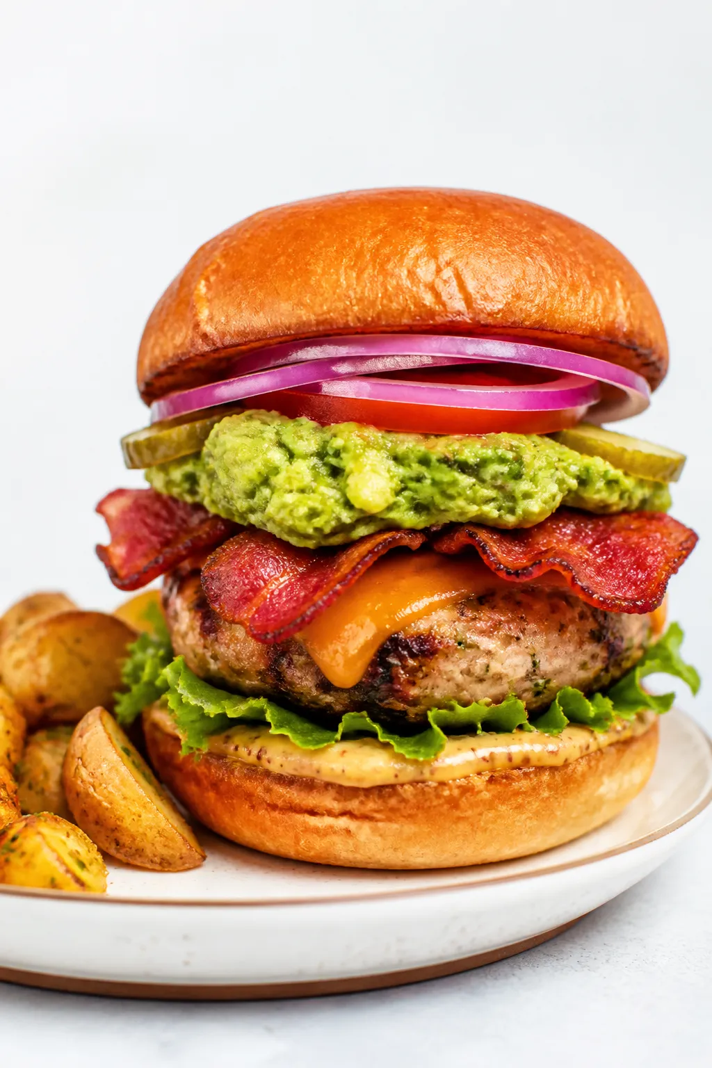 Final dish presentation: Fully assembled Protein Packed Avocado Bacon Burger on a toasted brioche bu