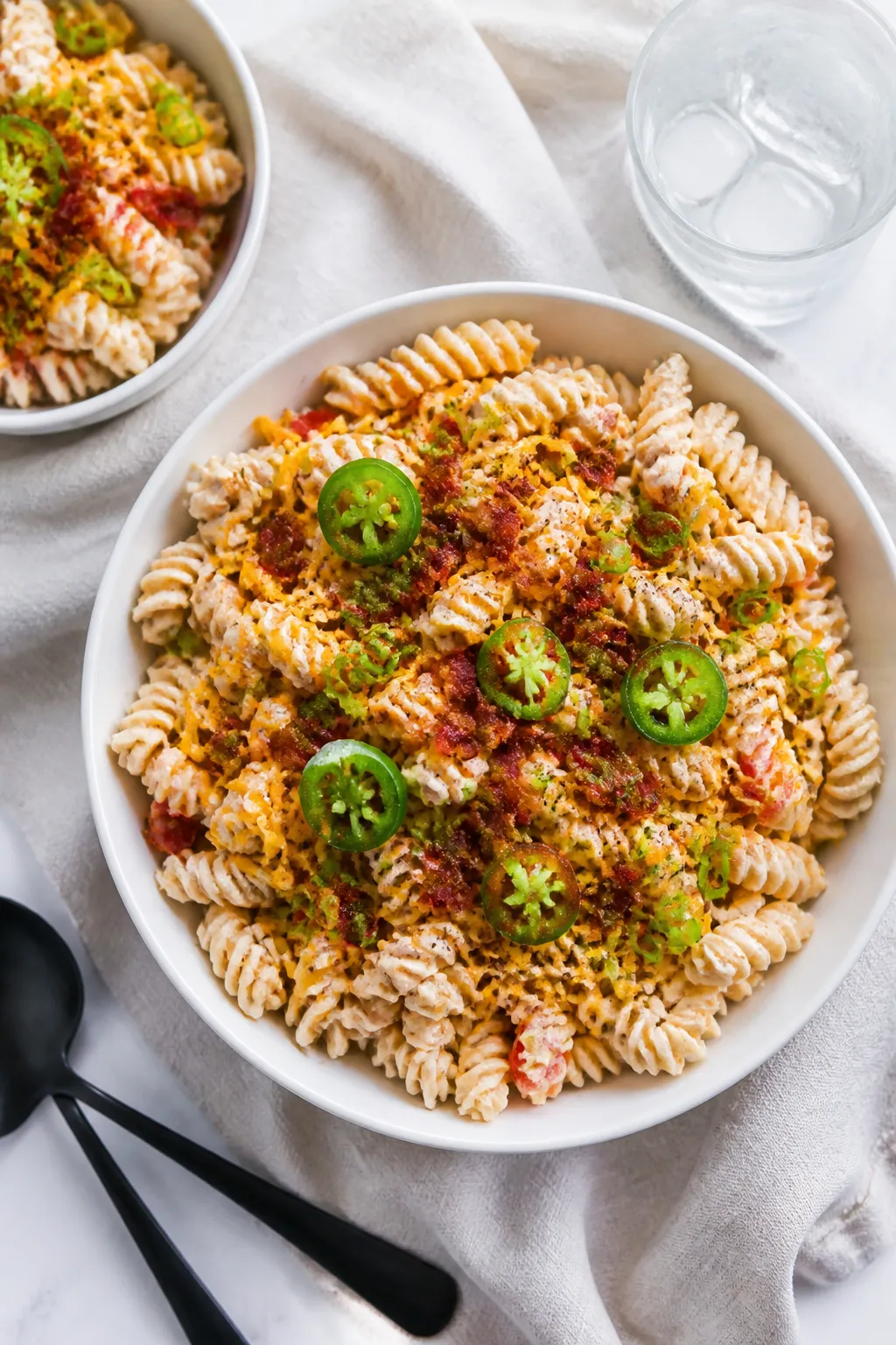 Final dish presentation: Restaurant-quality plated Crack Chicken Pasta Salad in a wide, shallow whit