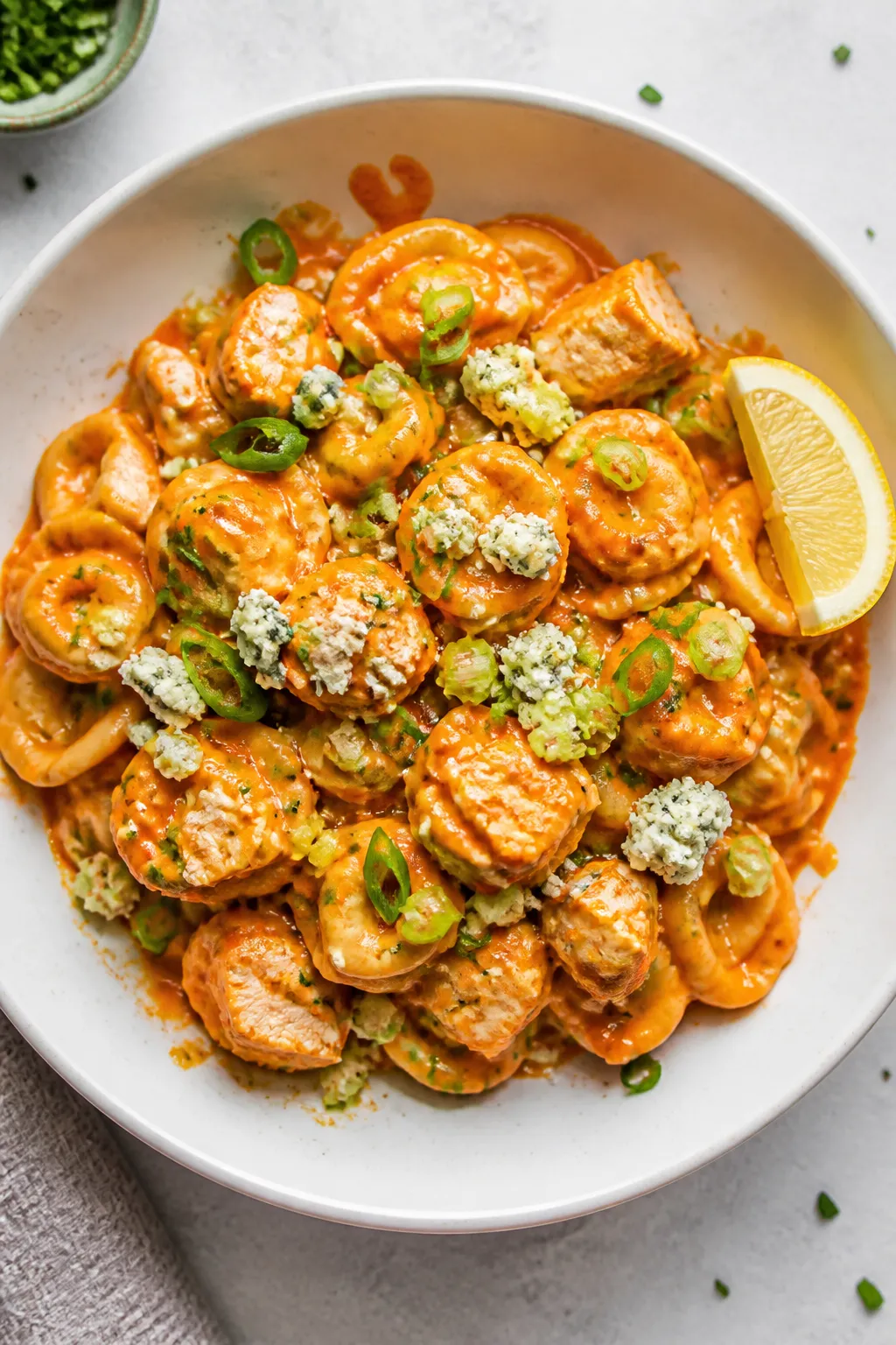 Final plated dish: Restaurant-quality bowl of High Protein Buffalo Chicken Tortellini plated in a sh