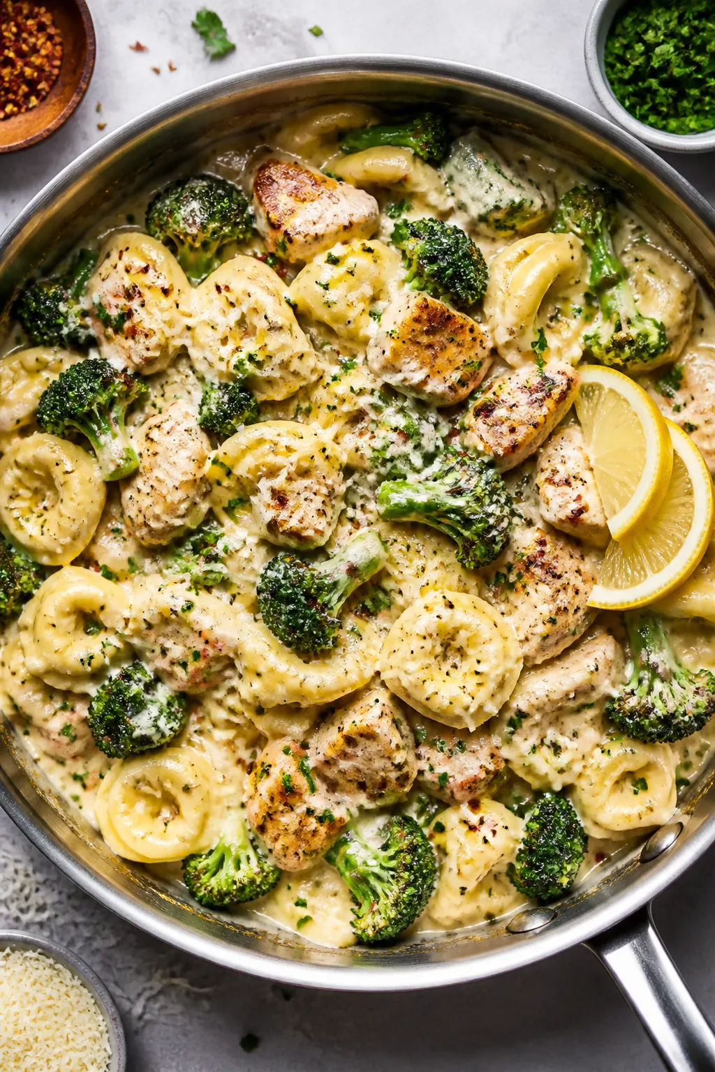 Tasty top view (overhead): One-pot high protein chicken broccoli tortellini just finished on the sto
