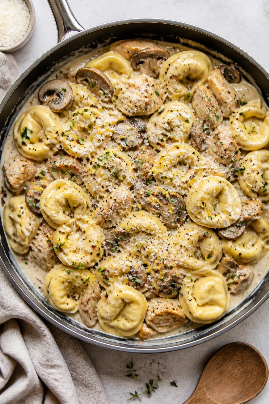 Tasty top view, overhead: Overhead shot of creamy mushroom chicken tortellini just combined in the s