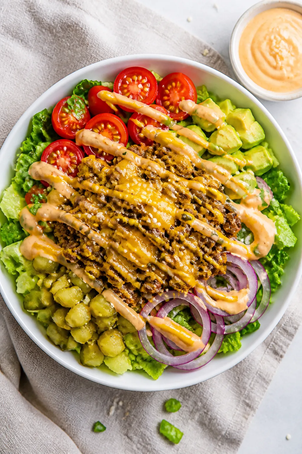 Tasty top view: Overhead shot of a High Protein Cheeseburger Bowl fully assembled—crisp chopped ro