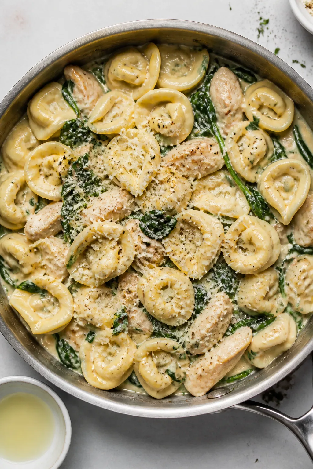 Tasty top view: Overhead shot of Chicken Alfredo Tortellini just tossed together in the pan—pillow