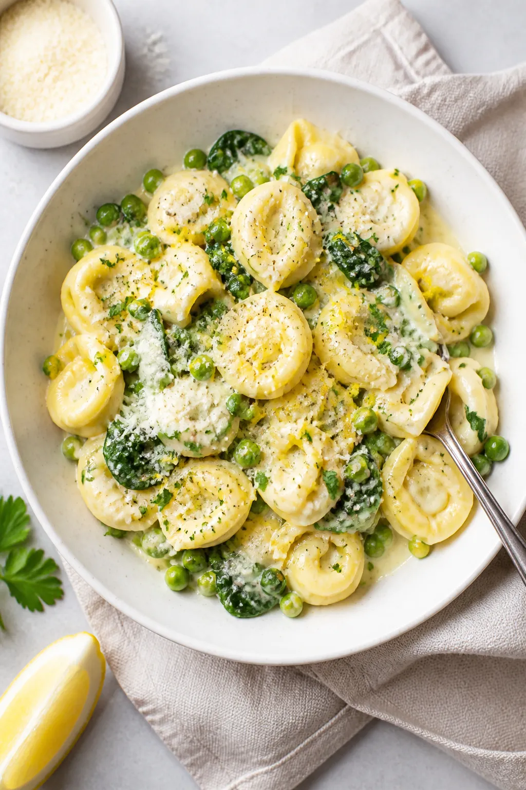 Tasty top view: Overhead shot of Creamy Parmesan Tortellini just finished and tossed with baby spina