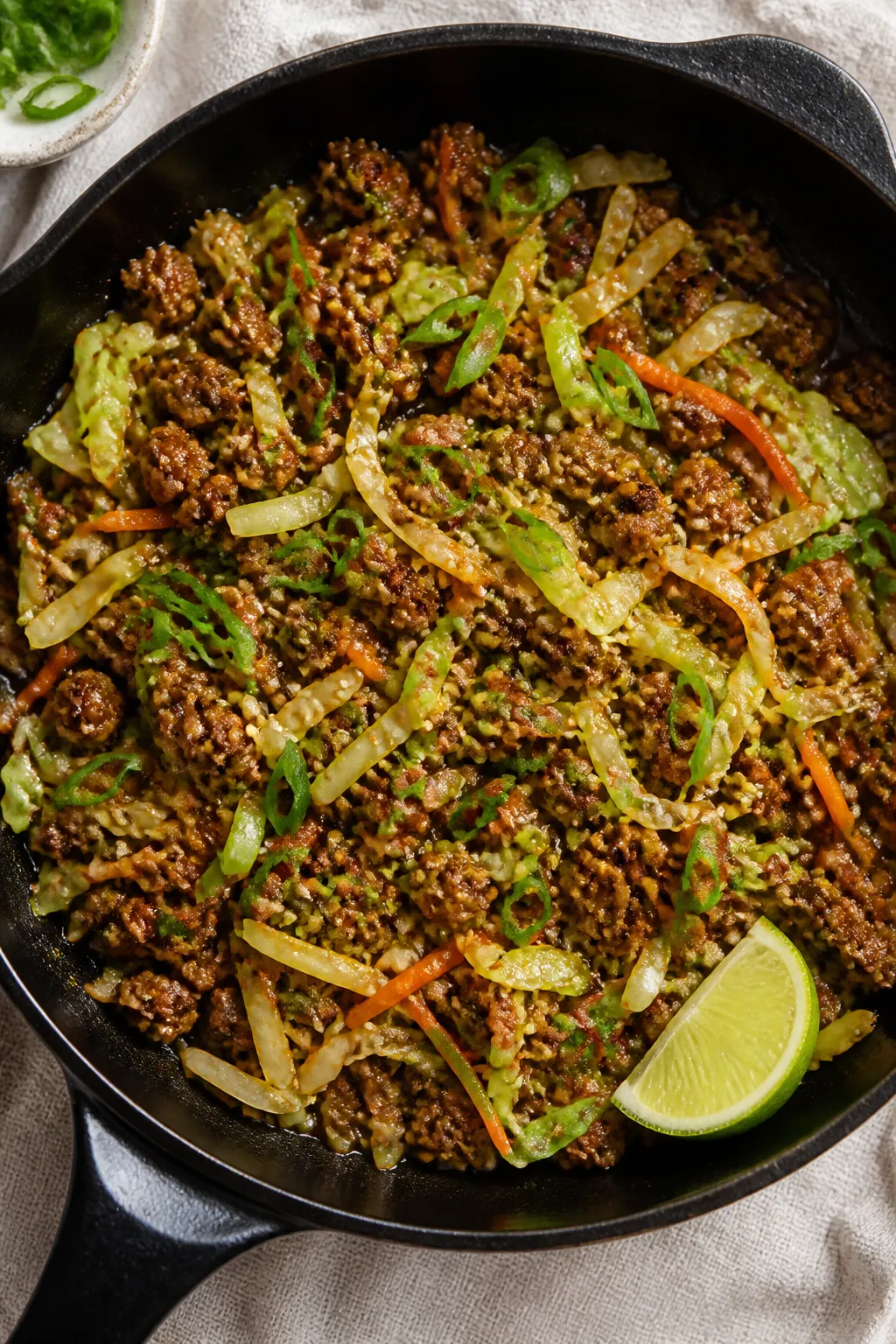 Tasty top view: Overhead shot of “pork egg roll in a bowl” just finished in the pan—juicy, lig