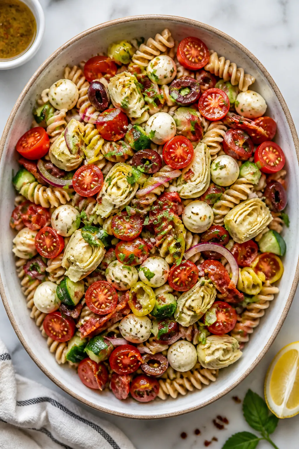 Tasty top view: Overhead shot of the finished Healthy Antipasto Pasta Salad in a wide, low ceramic s